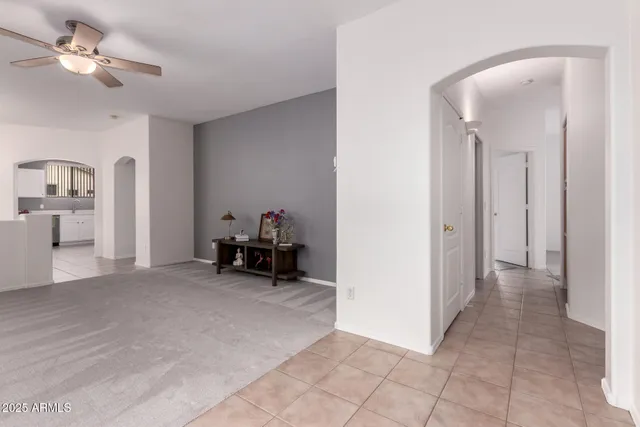 a view of a livingroom with furniture and a ceiling fan