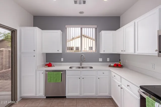 a kitchen with white cabinets and white appliances