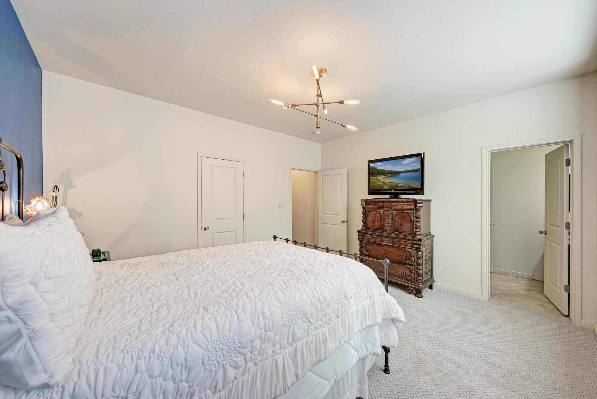 2605 Indian Creek Road Austin, TX 78734 - Photo 20 of 33 Bedroom featuring white walls and a blue accent wall