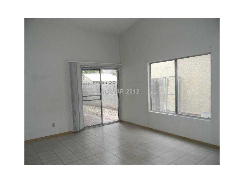 504 Inness Avenue Henderson, NV 89011 - Photo 2 of 29 Living Room. LIVING ROOM WITH SLIDING GLASS DOOR TO THE PATIO AREA
