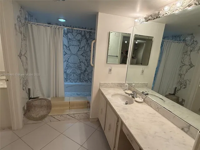 a bathroom with a tub sink and shower