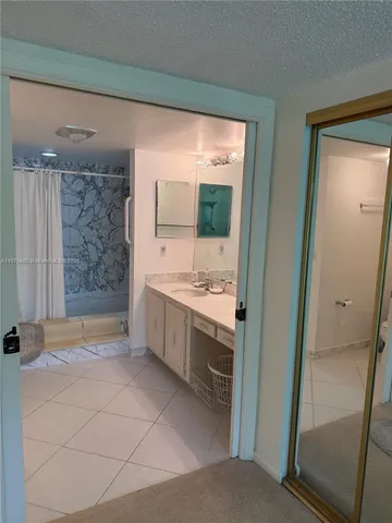 a bathroom with a double vanity sink toilet and shower