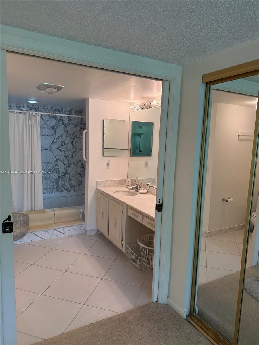 199 Ocean Ln Drive, Unit 203 Key Biscayne, FL 33149 - Photo 14 of 17 a bathroom with a double vanity sink toilet and shower