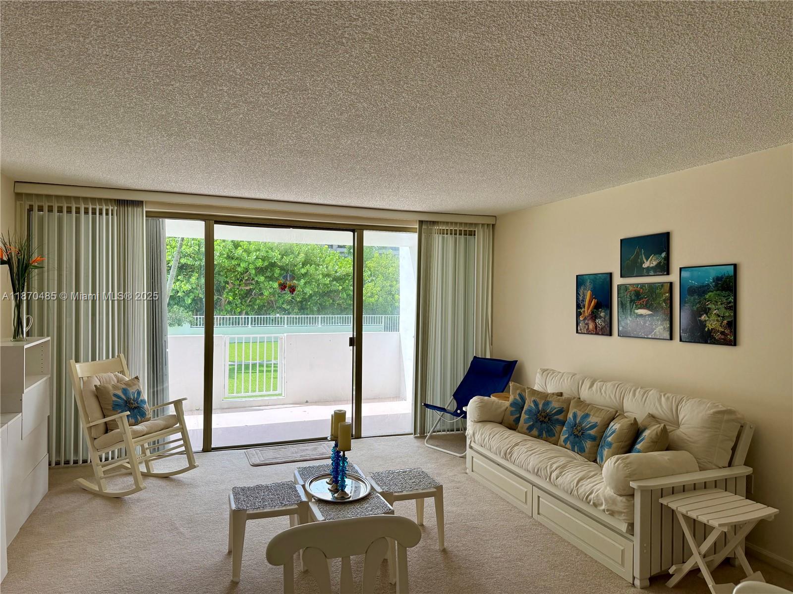 199 Ocean Ln Drive, Unit 203 Key Biscayne, FL 33149 - Photo 15 of 17 a living room with furniture and floor to ceiling windows