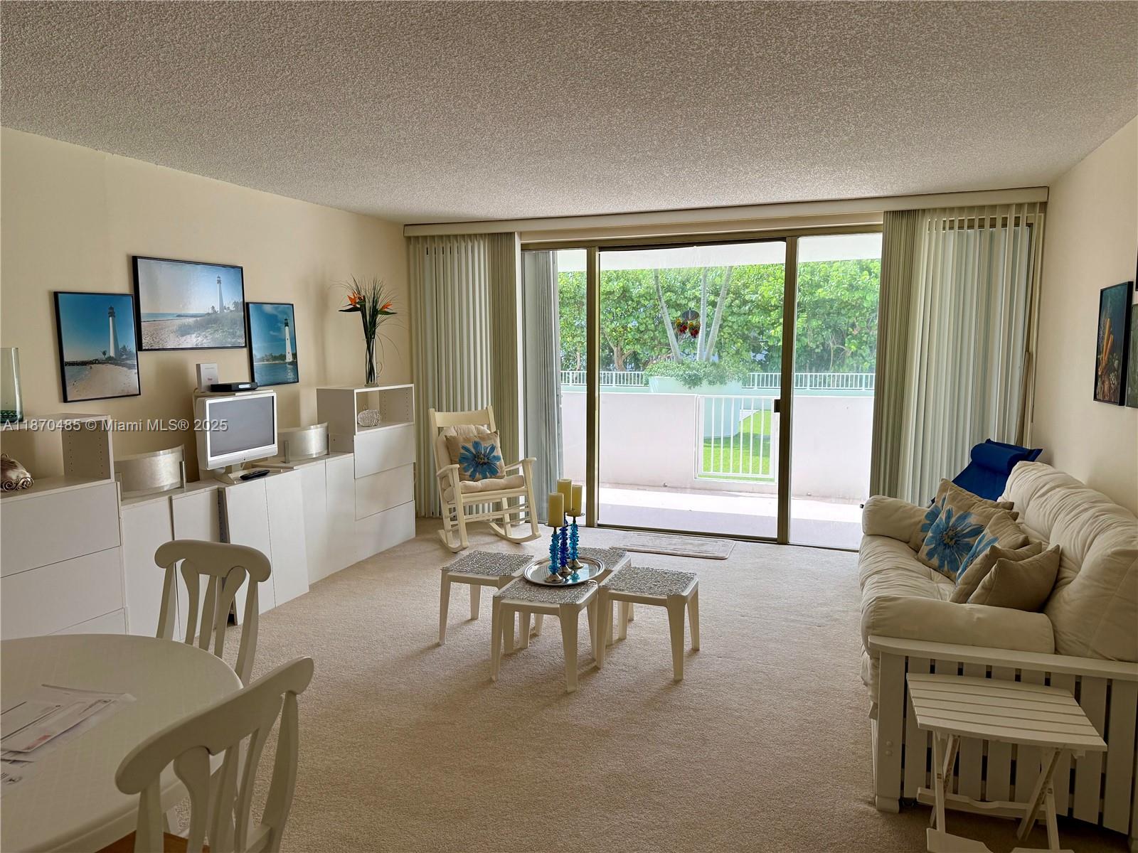 199 Ocean Ln Drive, Unit 203 Key Biscayne, FL 33149 - Photo 16 of 17 a living room with furniture and a large window