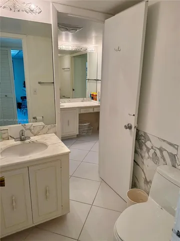 a bathroom with a sink a toilet and mirror