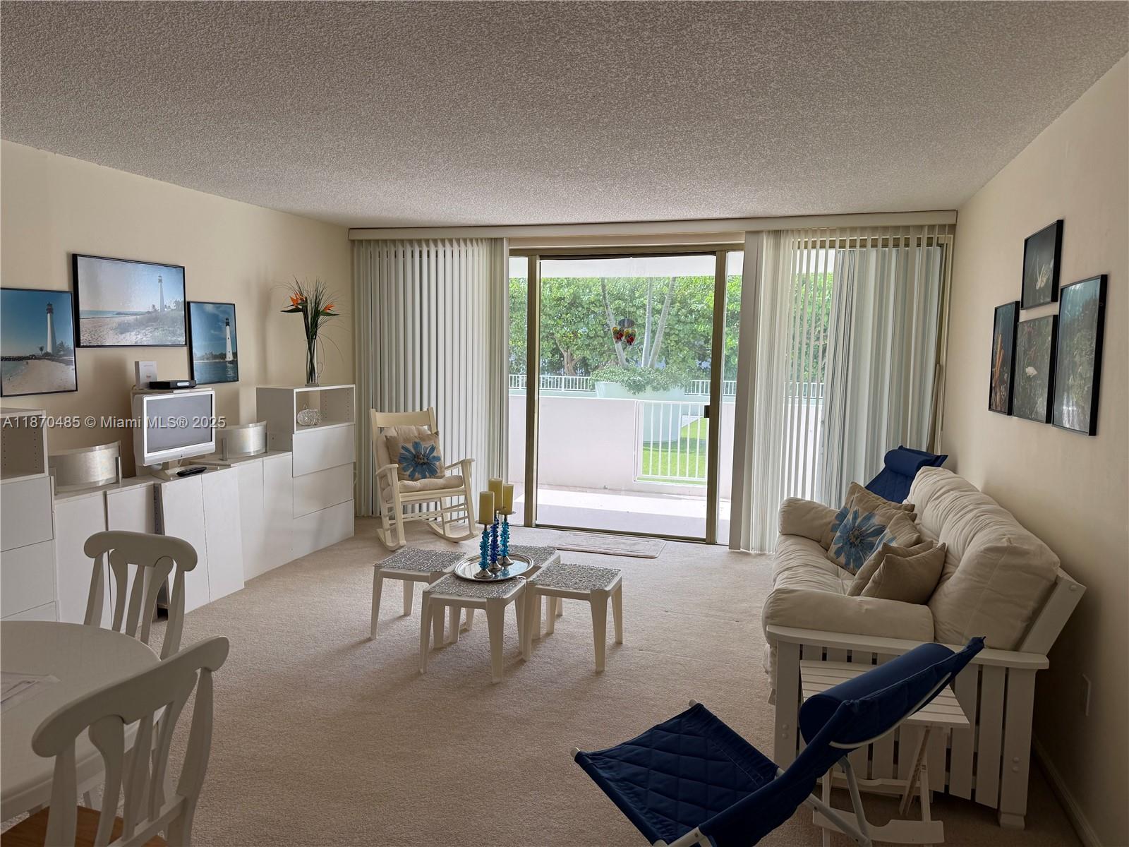 199 Ocean Ln Drive, Unit 203 Key Biscayne, FL 33149 - Photo 6 of 17 a living room with furniture and a window