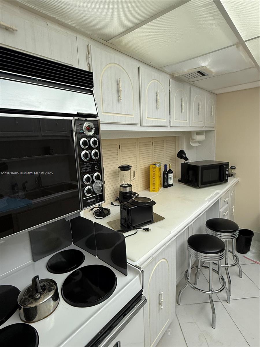 199 Ocean Ln Drive, Unit 203 Key Biscayne, FL 33149 - Photo 8 of 17 a kitchen with a sink a stove and cabinets