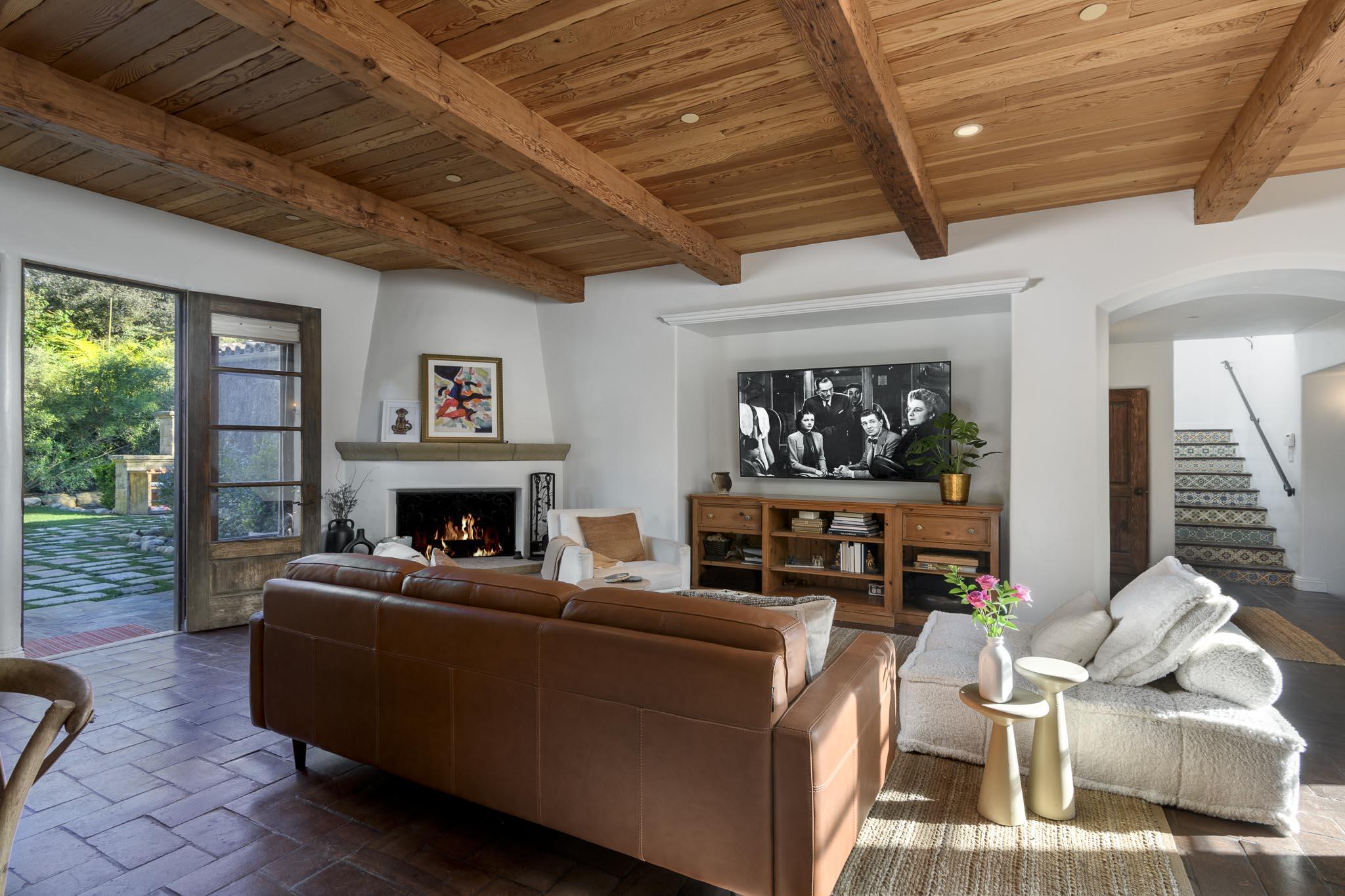 2222 East Valley Road Montecito, CA 93108 - Photo 15 of 30 a living room with furniture a fireplace and a floor to ceiling window