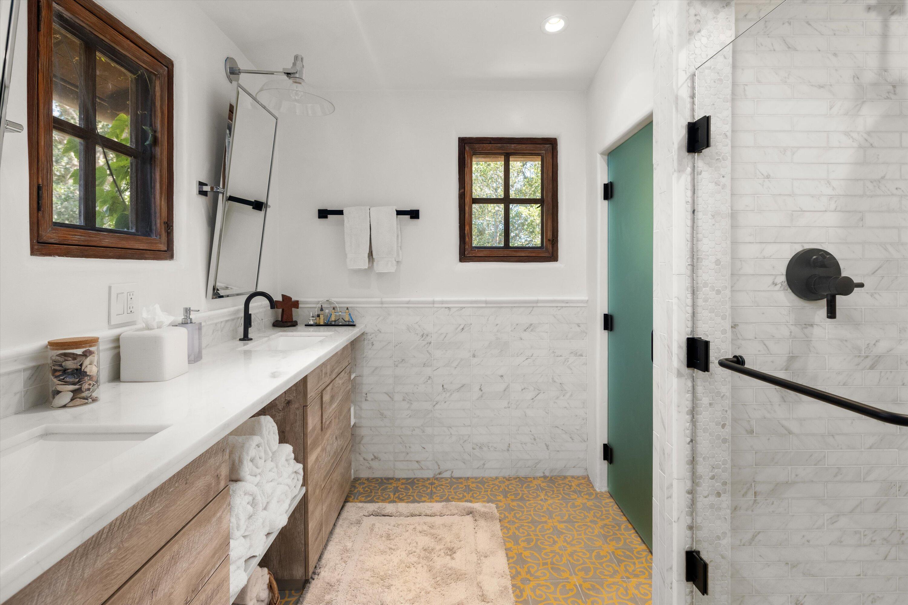 2222 East Valley Road Montecito, CA 93108 - Photo 19 of 30 a bathroom with a granite countertop sink a mirror and shower