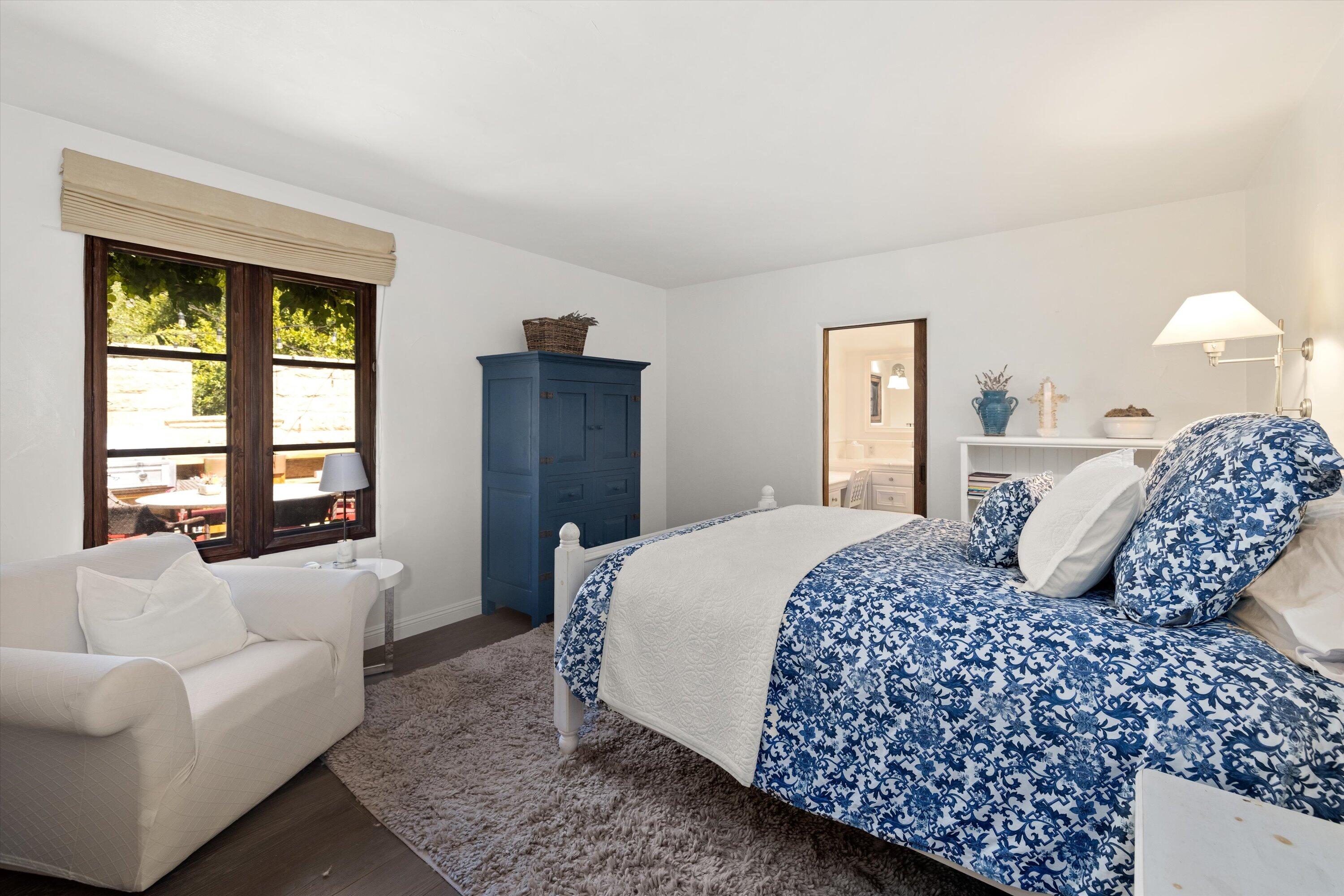 2222 East Valley Road Montecito, CA 93108 - Photo 20 of 30 a bedroom with a large bed couch and a window