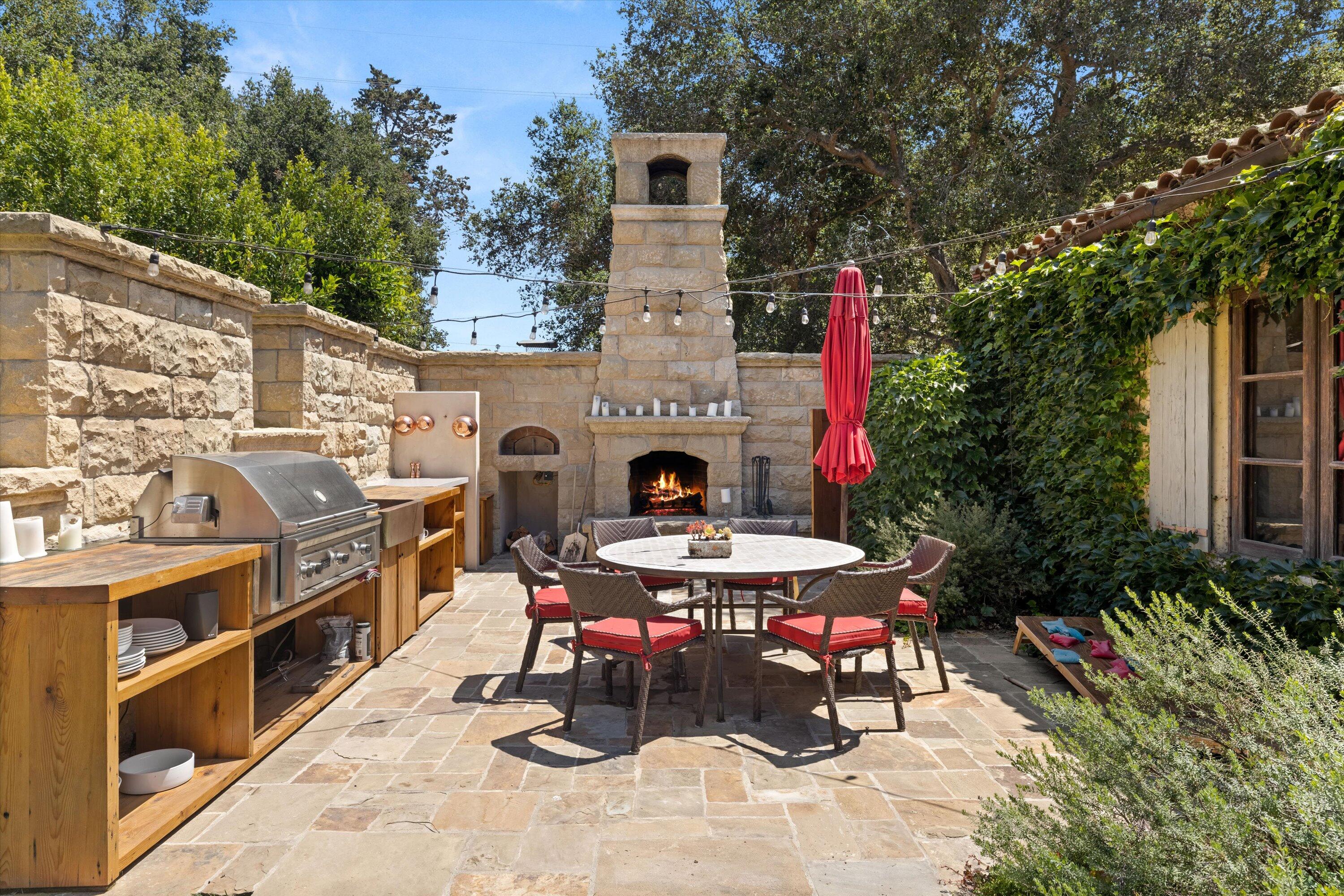 2222 East Valley Road Montecito, CA 93108 - Photo 21 of 30 a view of a chairs and table in the back yard of the house