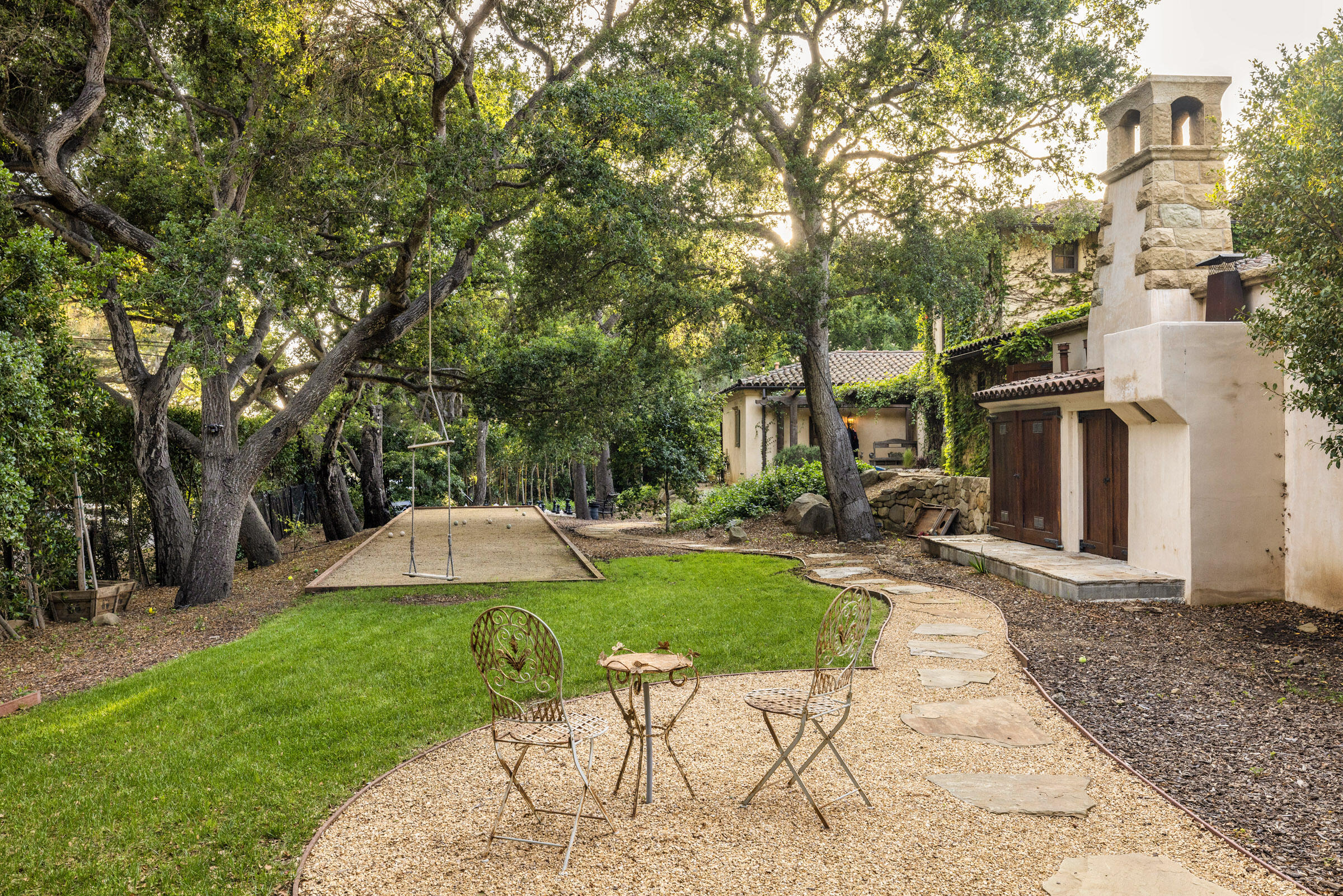 2222 East Valley Road Montecito, CA 93108 - Photo 25 of 30 a view of a patio with table and chairs under an umbrella