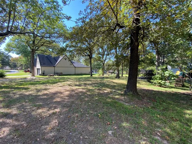 a view of a house with a tree and a yard