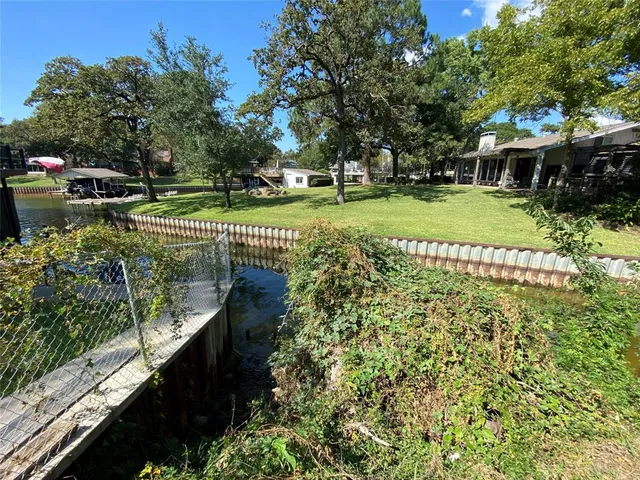 a view of a garden with a bench in the garden