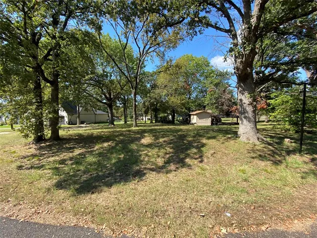 a view of outdoor space with trees all around