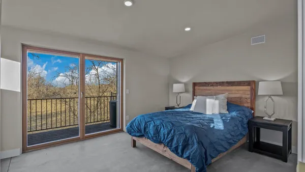 a bedroom with a bed and a night stand