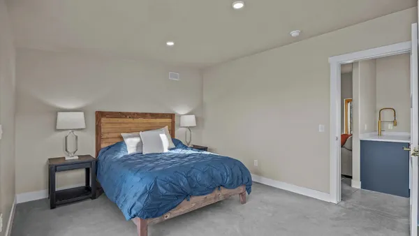 a bedroom with a bed and a night stand