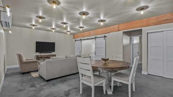 a living room with furniture and a chandelier