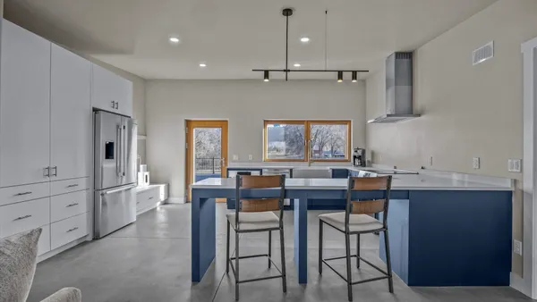 a kitchen that has a table and chairs in it