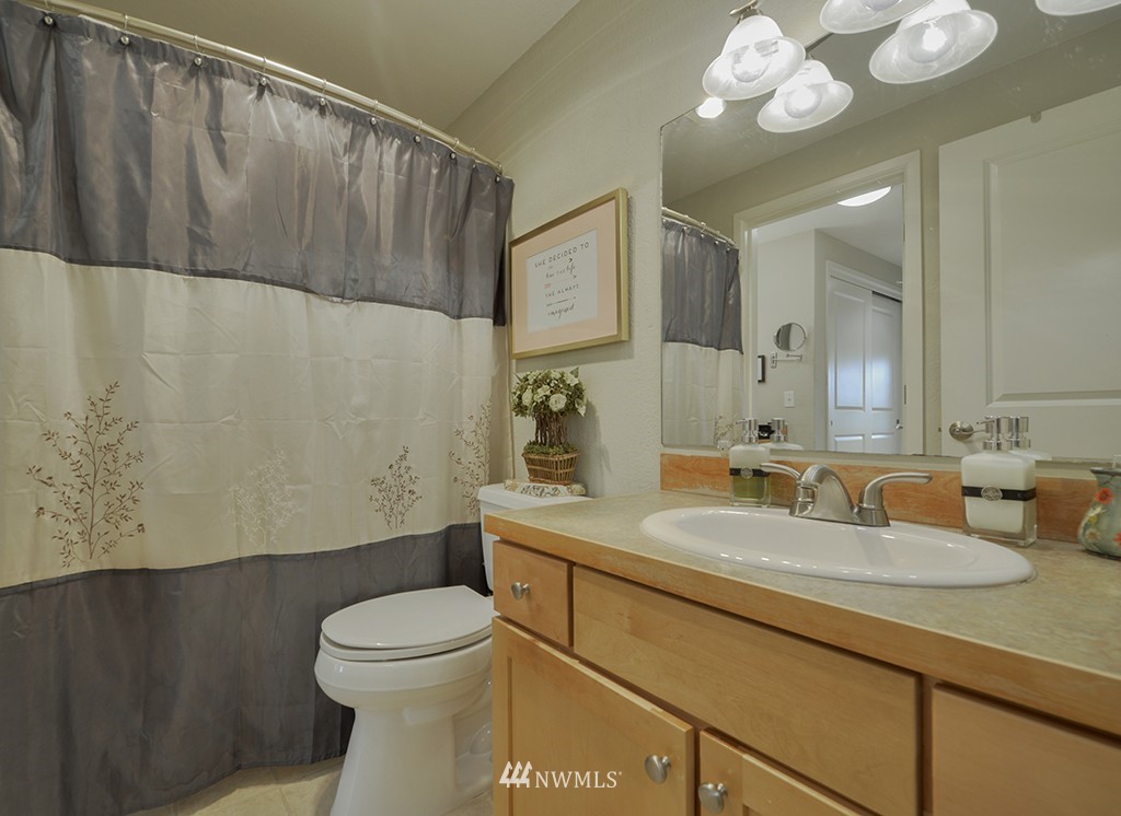 805 North 33rd Place Renton, WA 98056 - Photo 11 of 24 a bathroom with a toilet a sink and mirror