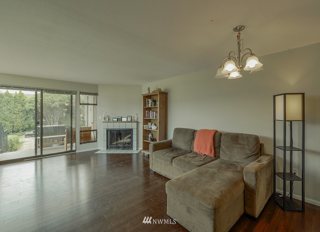 805 North 33rd Place Renton, WA 98056 - Photo 16 of 24 a living room with furniture large wooden floor and a fireplace