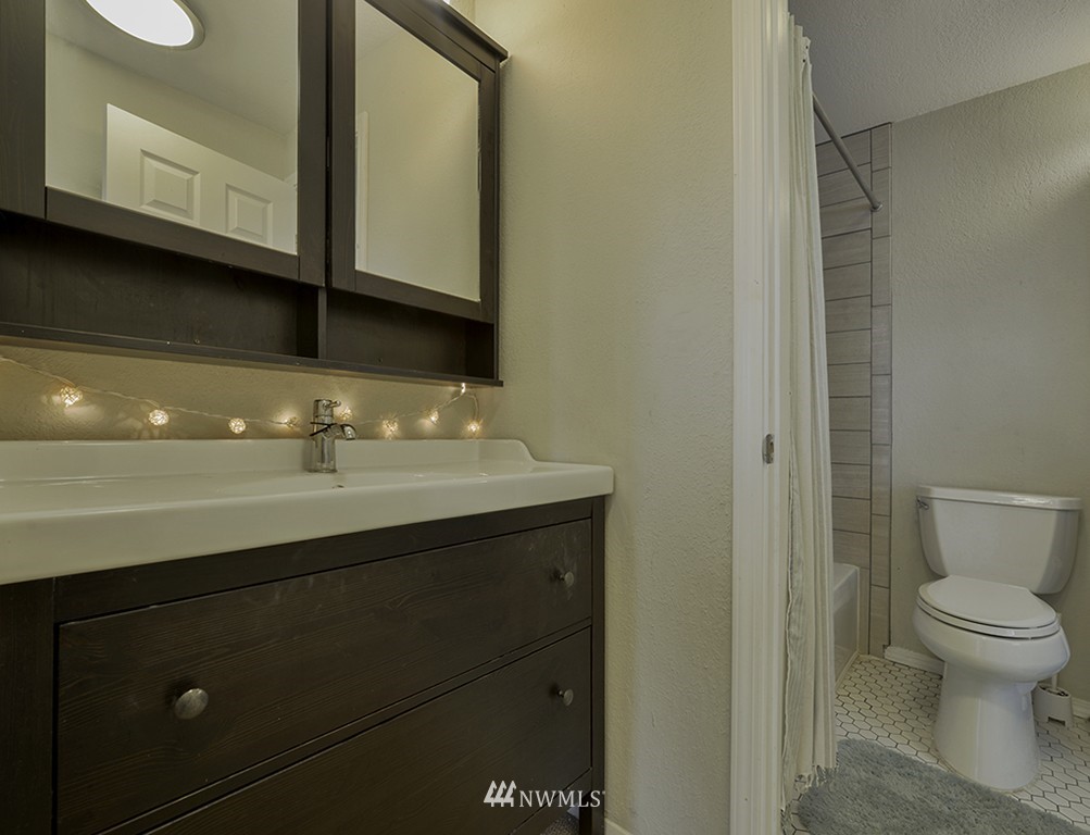 805 North 33rd Place Renton, WA 98056 - Photo 20 of 24 a bathroom with a sink a toilet and a mirror