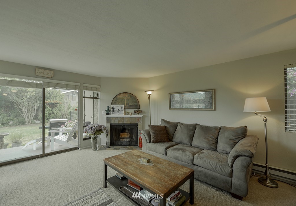 805 North 33rd Place Renton, WA 98056 - Photo 5 of 24 a living room with furniture a table and a fireplace