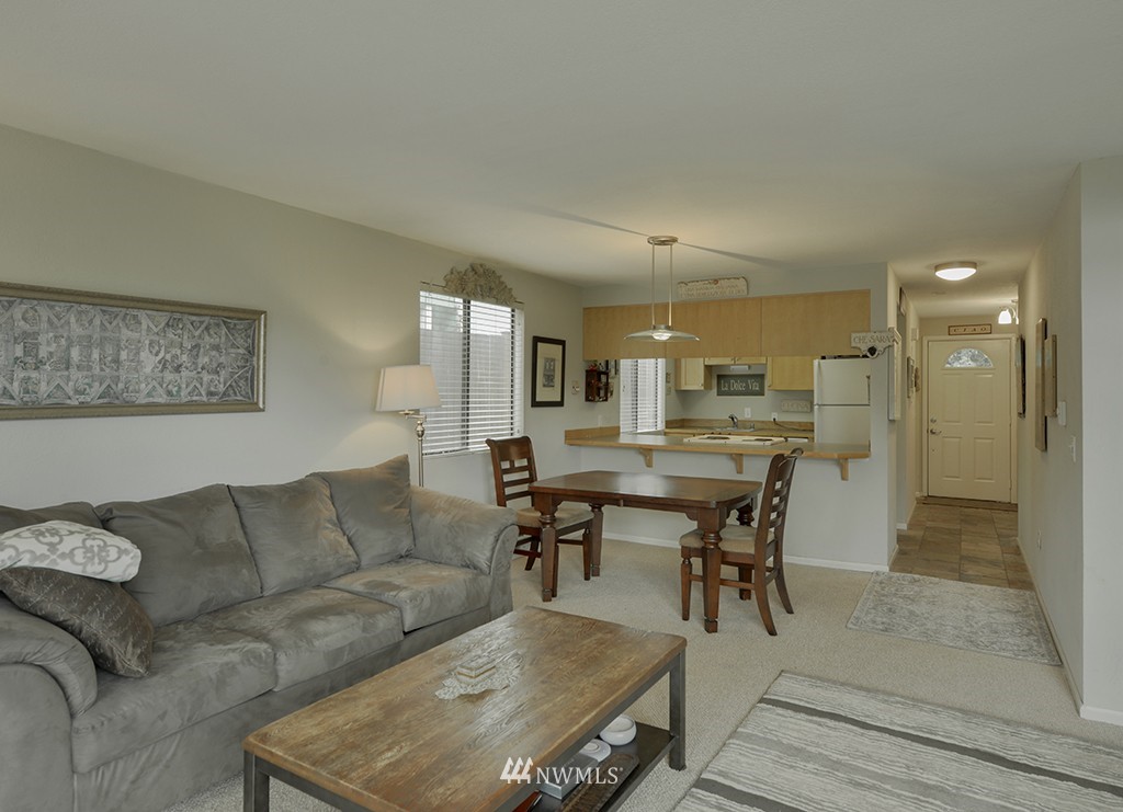 805 North 33rd Place Renton, WA 98056 - Photo 6 of 24 a living room with furniture and a dining table with kitchen view