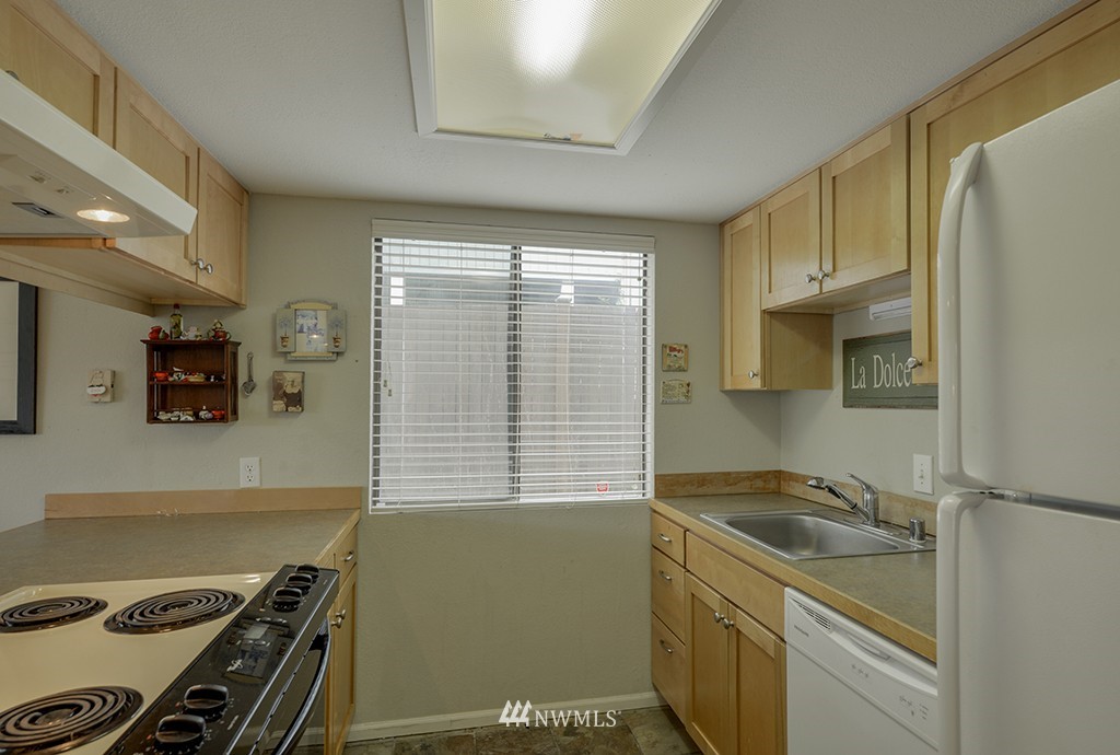 805 North 33rd Place Renton, WA 98056 - Photo 7 of 24 a kitchen with stainless steel appliances granite countertop a sink stove and refrigerator