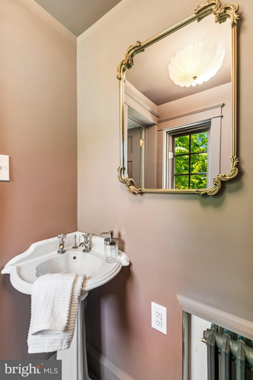 19 Farm Road Wayne, PA 19087 - Photo 21 of 50 a bathroom with a sink and mirror