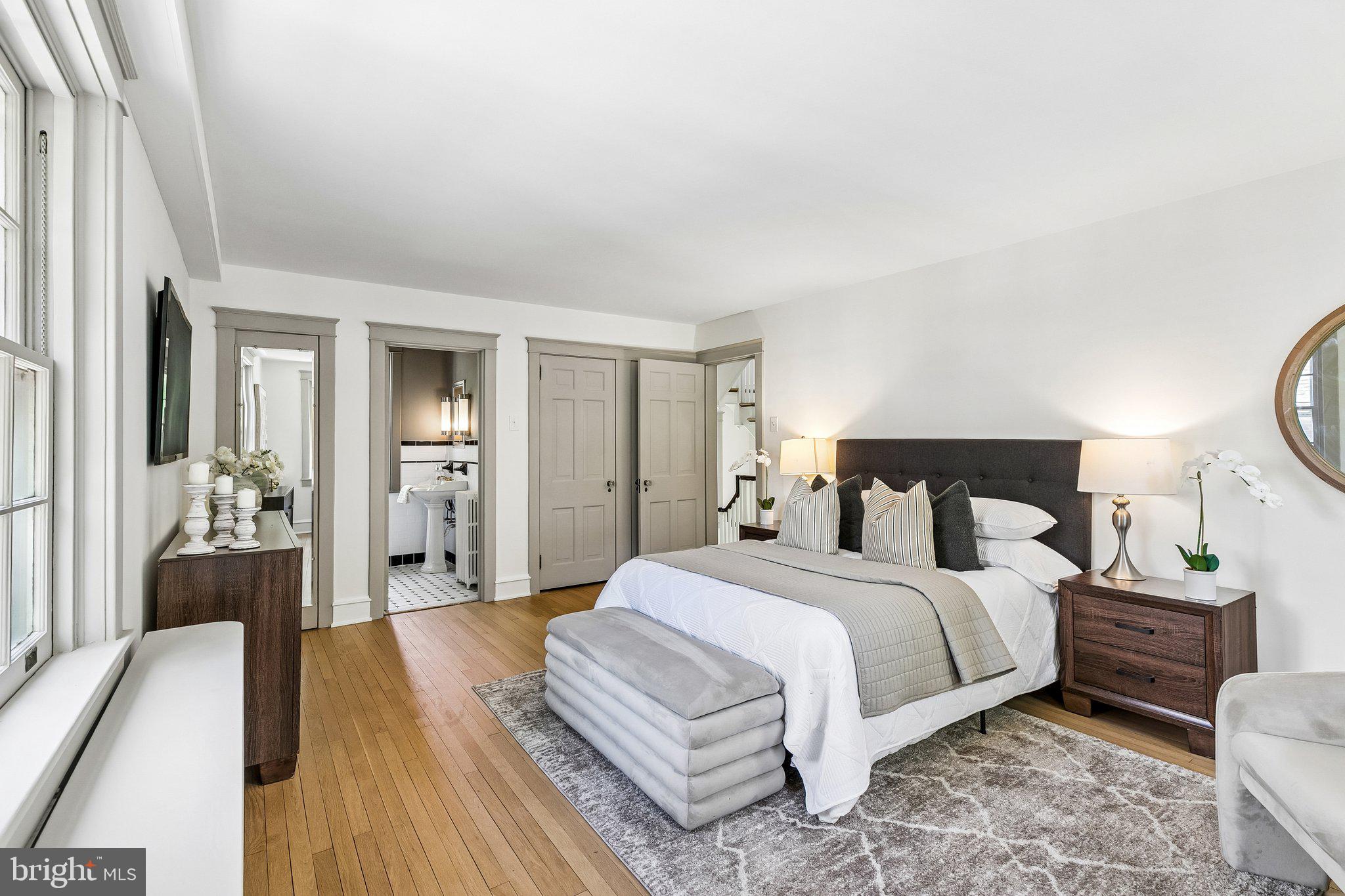 19 Farm Road Wayne, PA 19087 - Photo 22 of 50 a bedroom with a bed a mirror and lamp