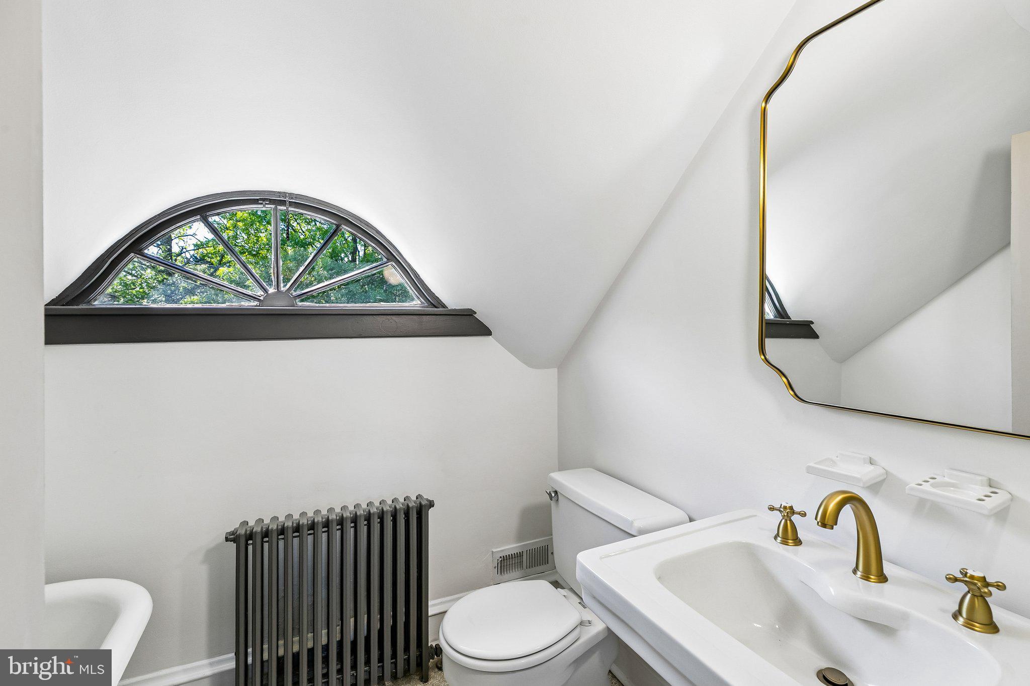 19 Farm Road Wayne, PA 19087 - Photo 38 of 50 a bathroom with a sink a toilet and a mirror