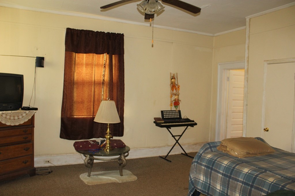 2081 Flint Road, Unit 2 Culloden, GA 31016 - Photo 4 of 7 a bedroom with a bed and a chandelier