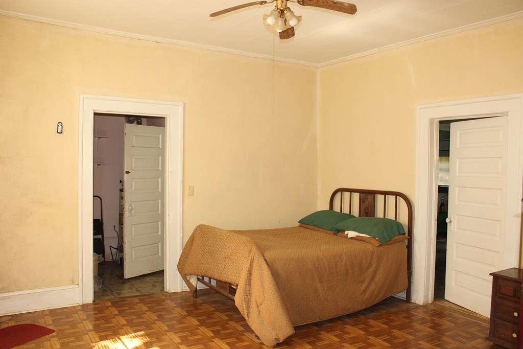 2081 Flint Road, Unit 2 Culloden, GA 31016 - Photo 5 of 7 a bedroom with a bed and a chandelier