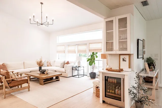 a dining hall with stainless steel appliances kitchen island granite countertop a table and chairs