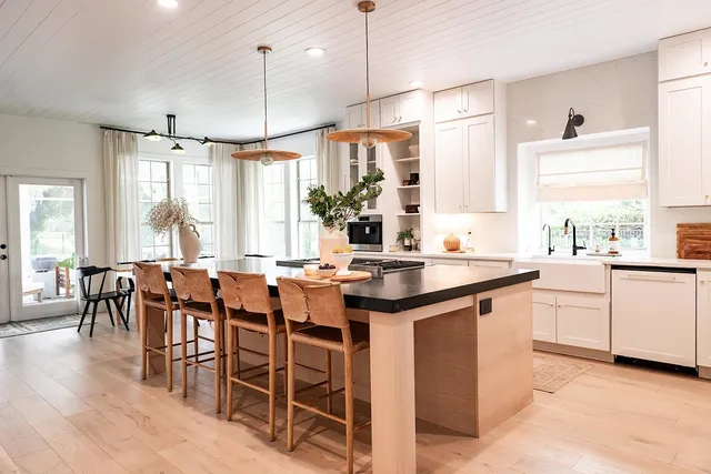 a dining table chairs and chandelier