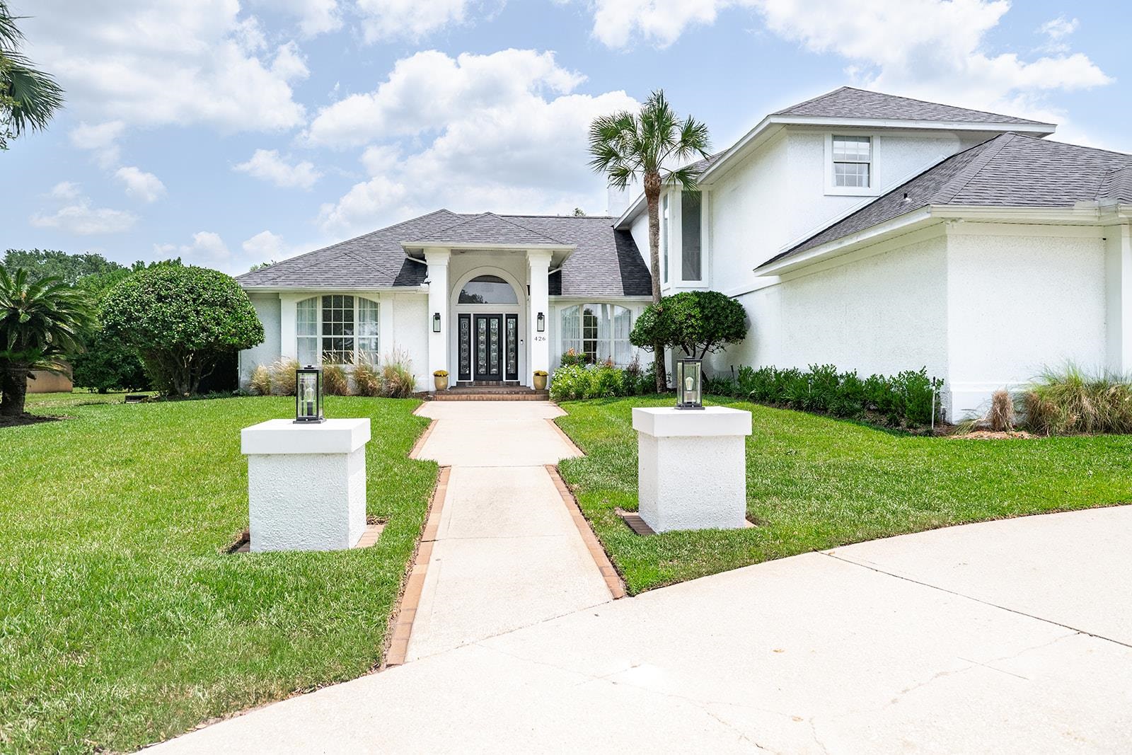 426 Marsh Point Circle St. Augustine, FL 32080 - Photo 2 of 87 a front view of a house with a yard and potted plants