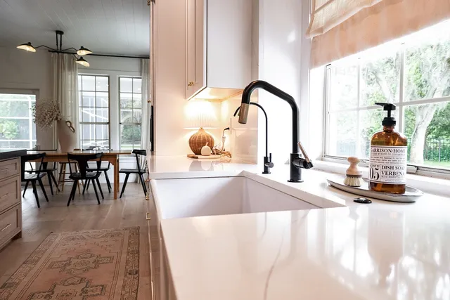 a bedroom with a bed lamp and a potted plant