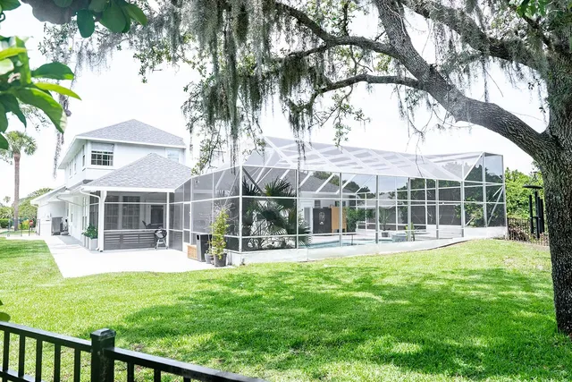 a front view of house with a garden and trees