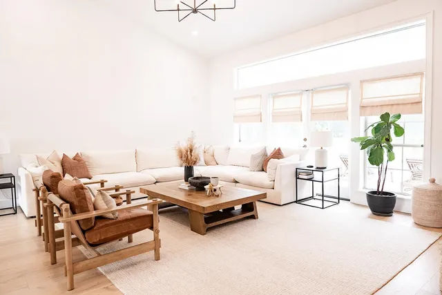 a living room with furniture a fireplace and a chandelier