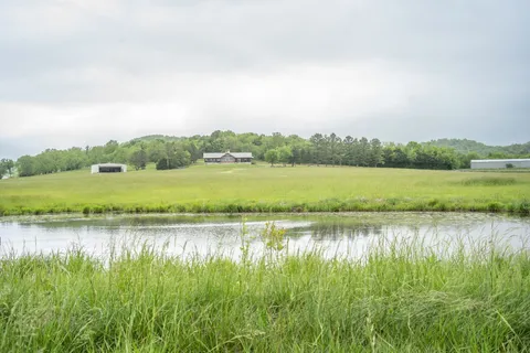 a view of a lake with houses in the back