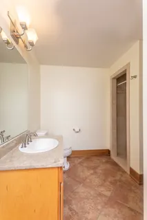 a view of a chairs and table in the balcony