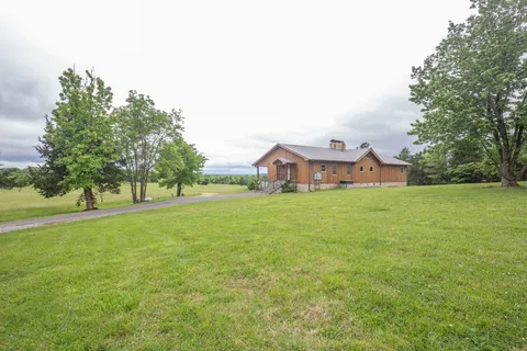 a front view of a house with a garden and yard