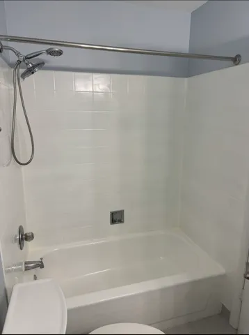 a bathroom with a bath tub and a shower