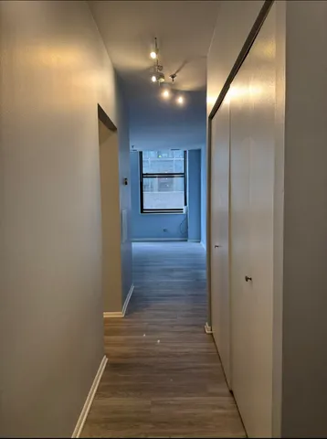 a view of hallway with wooden floor