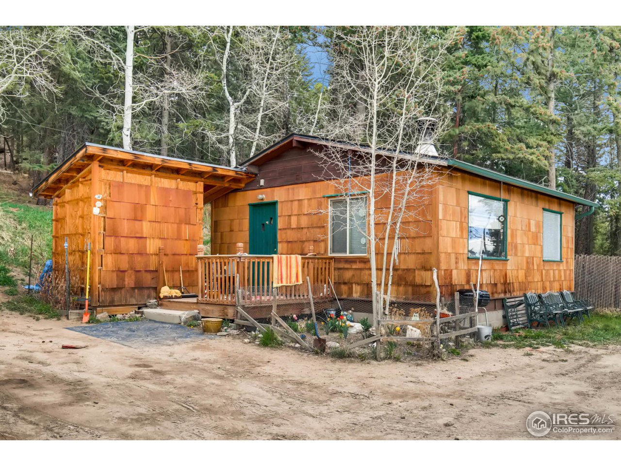 8537 Doubleheader Ranch Road Morrison, CO 80465 - Photo 14 of 40 a backyard of a house with yard and outdoor seating