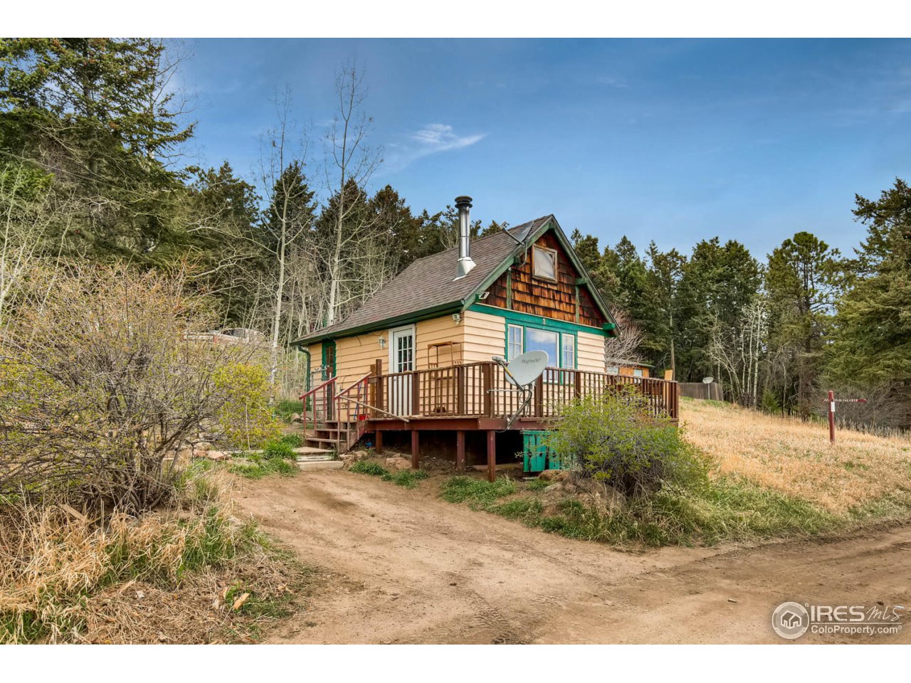 8537 Doubleheader Ranch Road Morrison, CO 80465 - Photo 15 of 40 a view of a house with a yard