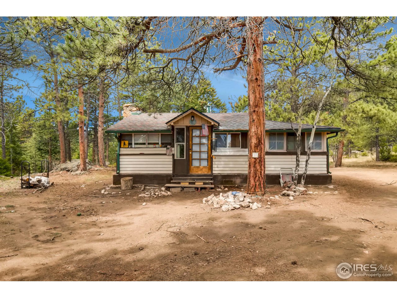 8537 Doubleheader Ranch Road Morrison, CO 80465 - Photo 18 of 40 a front view of a house with a yard