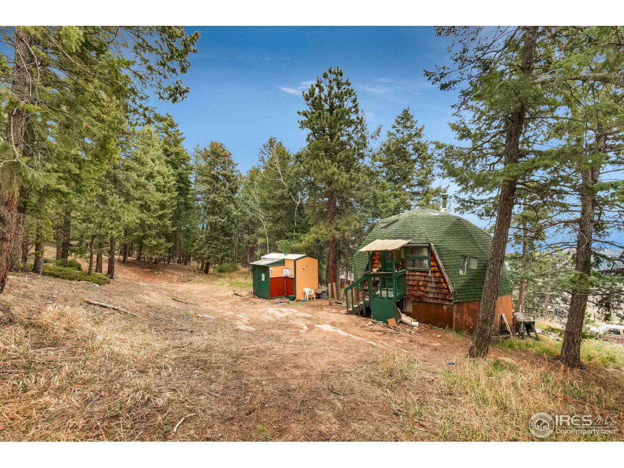 8537 Doubleheader Ranch Road Morrison, CO 80465 - Photo 22 of 40 a view of a wooden house with a yard